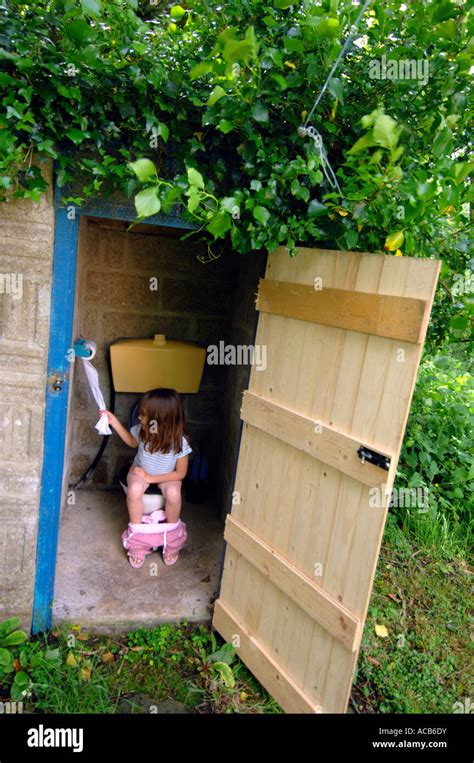 Amateur urinates in the outhouse as the watchman spies on her